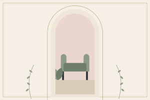 A green armchair beside a small plant