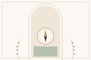 A brass compass on a pale table