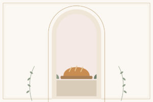 A golden loaf of bread resting on a wooden board
