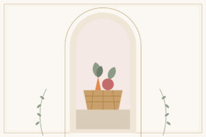 A woven basket with carrots, leaves, and a tomato